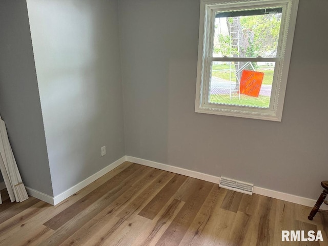 empty room featuring baseboards and wood finished floors