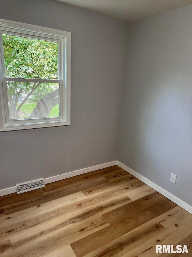 unfurnished room with wood finished floors and baseboards
