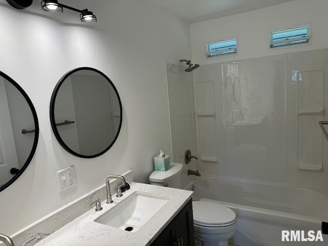 bathroom featuring toilet, vanity, and shower / bath combination