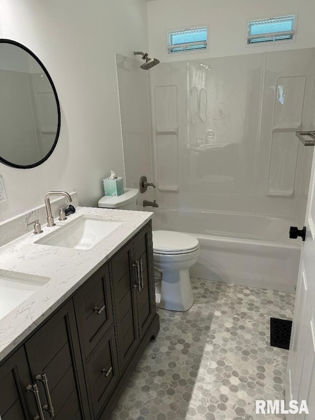 bathroom with toilet, bathing tub / shower combination, and double vanity