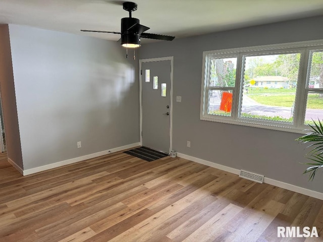entrance foyer with baseboards, ceiling fan, and light wood-type flooring