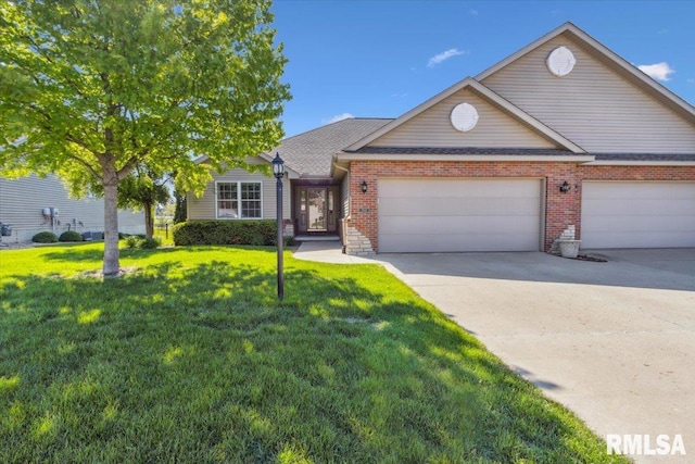 2512 Stonehenge Ct Unit 7Ashv, Peoria, IL 61615 - view of front of house featuring brick siding, a garage, concrete driveway, and a front lawn