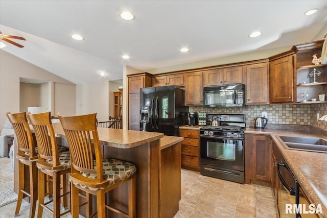2512 Stonehenge Ct Unit 7Ashv, Peoria, IL 61615 - kitchen featuring black appliances, a sink, tasteful backsplash, open shelves, and a kitchen breakfast bar