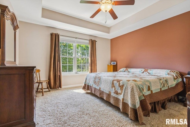 2512 Stonehenge Ct Unit 7Ashv, Peoria, IL 61615 - carpeted bedroom featuring baseboards, ceiling fan, and a tray ceiling