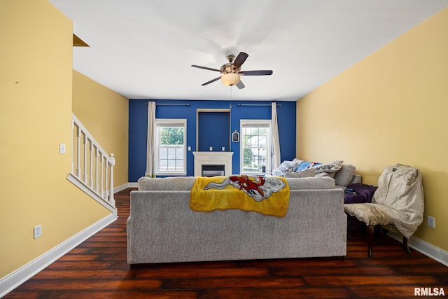 3329 W King James Rd, Peoria, IL 61615 - living area with stairs, ceiling fan, wood finished floors, baseboards, and a fireplace