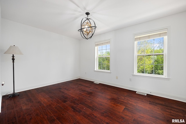 3329 W King James Rd, Peoria, IL 61615 - unfurnished room with a chandelier, dark wood-type flooring, and baseboards