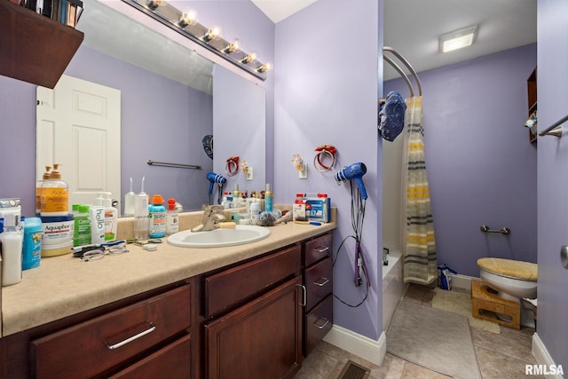 3329 W King James Rd, Peoria, IL 61615 - bathroom with vanity, toilet, shower / tub combo with curtain, tile patterned floors, and baseboards