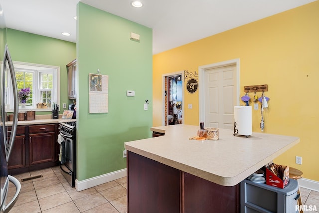 3329 W King James Rd, Peoria, IL 61615 - kitchen with appliances with stainless steel finishes, light tile patterned flooring, light countertops, baseboards, and recessed lighting