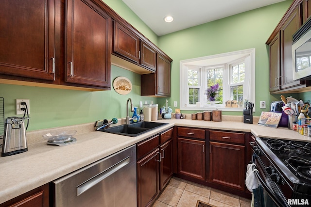 3329 W King James Rd, Peoria, IL 61615 - kitchen with a sink, stainless steel appliances, light tile patterned floors, light countertops, and recessed lighting