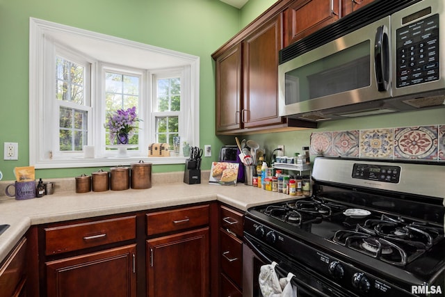 3329 W King James Rd, Peoria, IL 61615 - kitchen featuring appliances with stainless steel finishes, light countertops, and plenty of natural light
