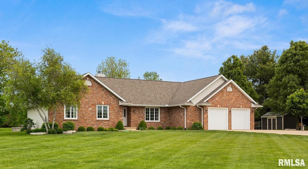 view of front facade with an attached garage, a front lawn, driveway, and brick siding