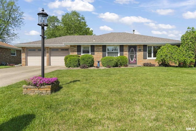 single story home featuring a garage, driveway, a front lawn, brick siding, and roof with shingles