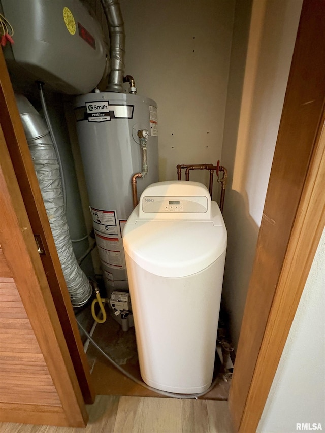 utility room featuring water heater