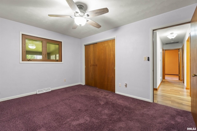 unfurnished bedroom with carpet, baseboards, and a closet