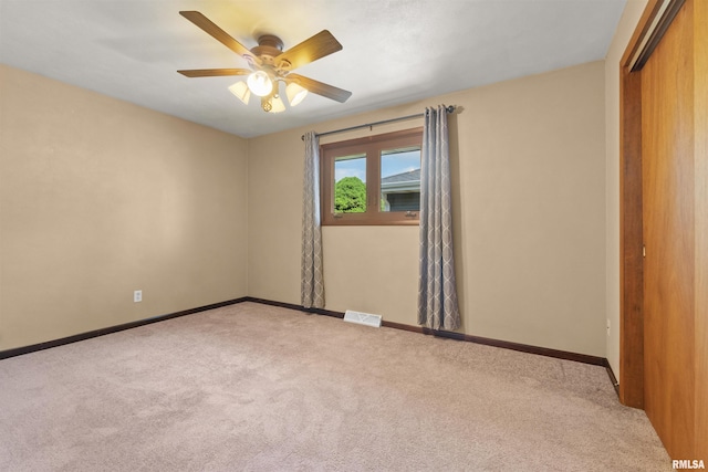 unfurnished bedroom featuring carpet, a closet, baseboards, and ceiling fan