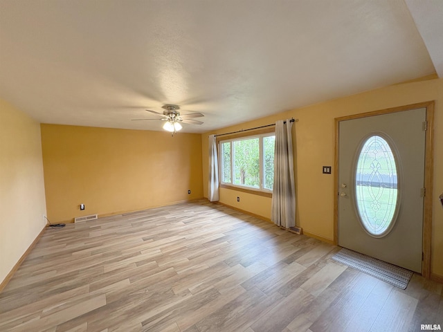 entrance foyer featuring ceiling fan, light wood finished floors, and baseboards