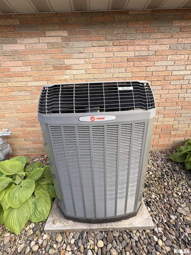 exterior view of central air condition unit and brick siding