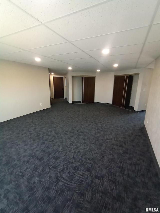 19478 Springfield Rd, Groveland, IL 61535 - finished below grade area with dark colored carpet, a drop ceiling, recessed lighting, and baseboards
