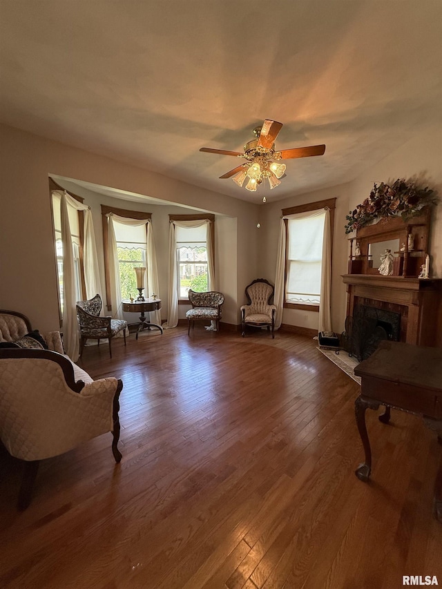 111 N Broadway St, Lewistown, IL 61542 - living area with a ceiling fan, a fireplace, and wood finished floors