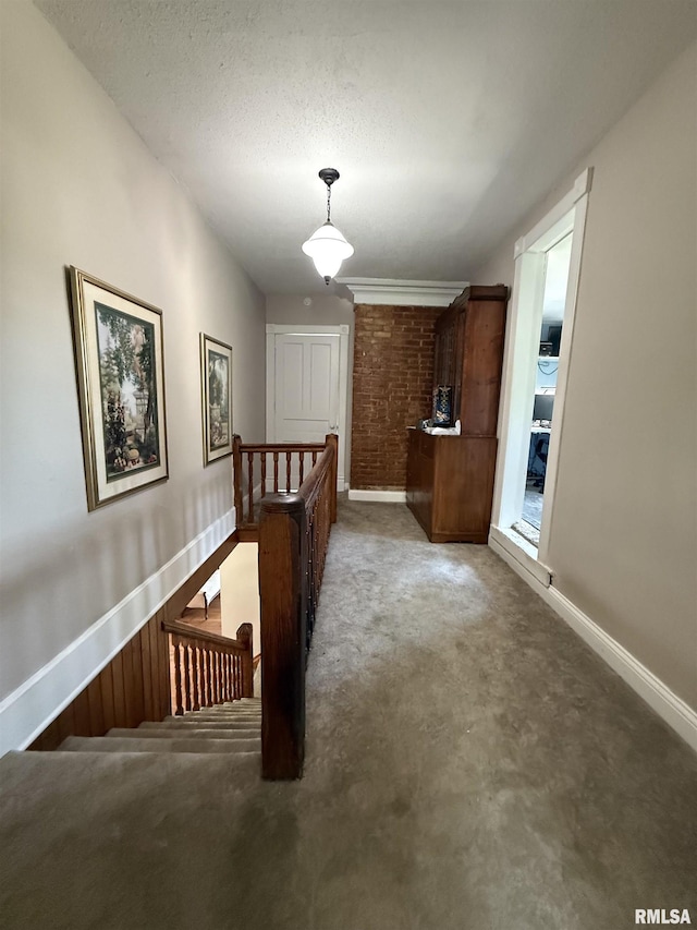 111 N Broadway St, Lewistown, IL 61542 - hall with an upstairs landing, carpet, baseboards, and a textured ceiling