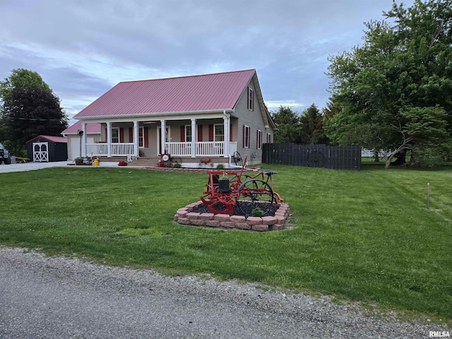 212 Conch Dr, La Harpe, IL 61450 - view of front of home featuring a porch, metal roof, and a garage