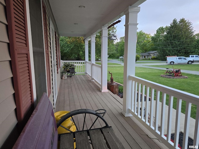 212 Conch Dr, La Harpe, IL 61450 - wooden deck featuring a porch and a lawn