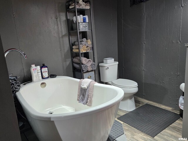 212 Conch Dr, La Harpe, IL 61450 - full bathroom with wood finished floors, a soaking tub, and toilet