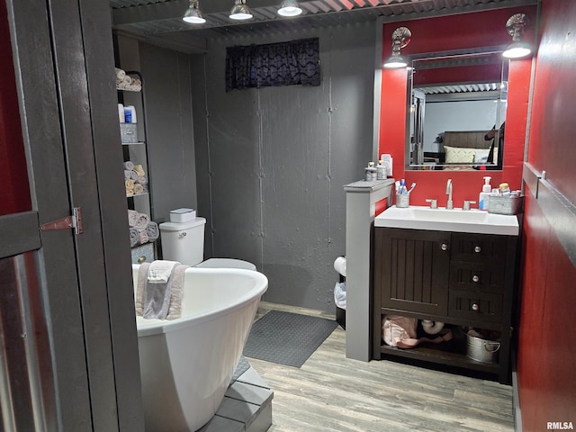212 Conch Dr, La Harpe, IL 61450 - full bath featuring wood finished floors, a freestanding bath, vanity, and baseboards