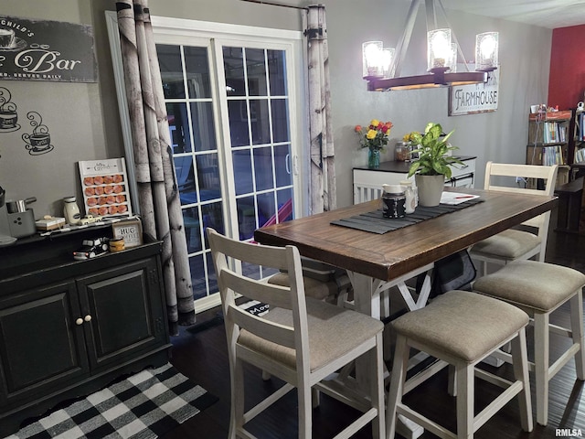 212 Conch Dr, La Harpe, IL 61450 - dining space featuring a chandelier and dark wood-type flooring
