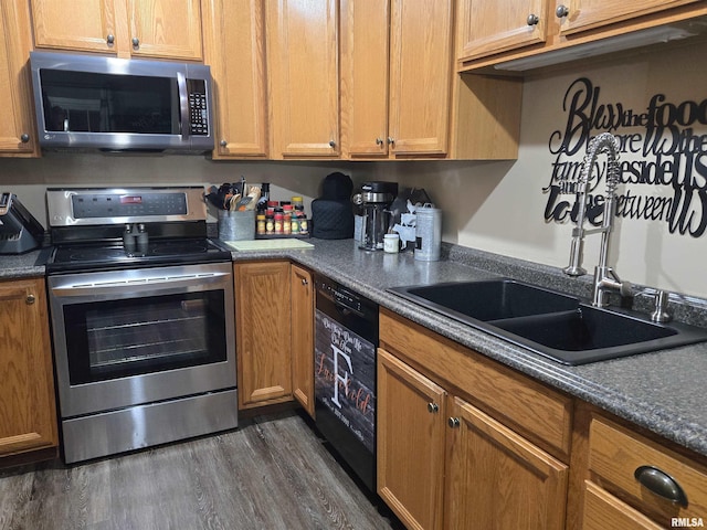 212 Conch Dr, La Harpe, IL 61450 - kitchen featuring stainless steel appliances, dark wood-type flooring, dark countertops, and brown cabinets