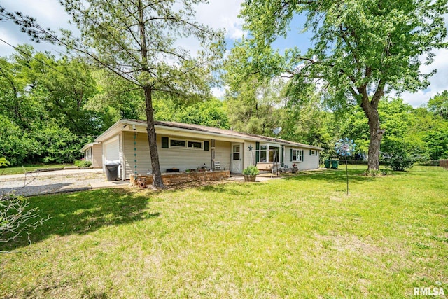 1425 N Vaughn Ave, West Peoria, IL 61604 - view of front of house featuring driveway, a front yard, view of scattered trees, and a garage