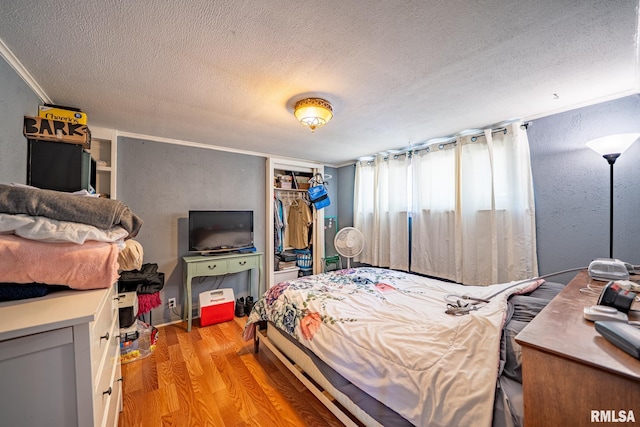 1425 N Vaughn Ave, West Peoria, IL 61604 - bedroom with a textured ceiling, light wood-type flooring, and a closet