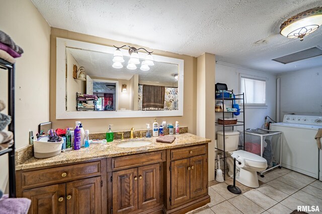 1425 N Vaughn Ave, West Peoria, IL 61604 - full bathroom with washer / dryer, a textured ceiling, tile patterned floors, vanity, and toilet