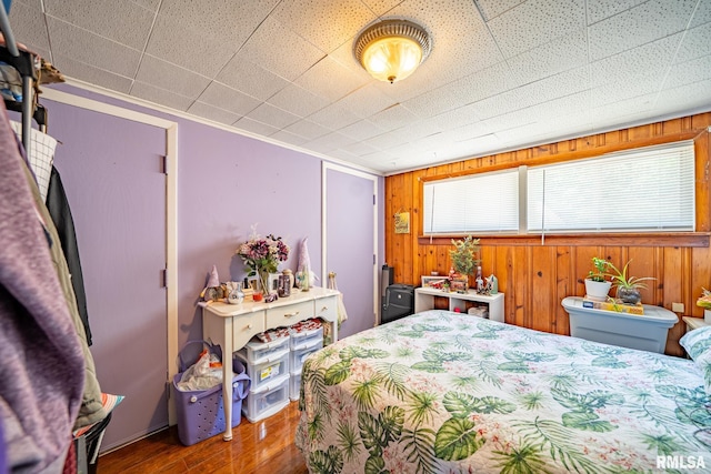 1425 N Vaughn Ave, West Peoria, IL 61604 - bedroom featuring wood finished floors, wooden walls, and ornamental molding