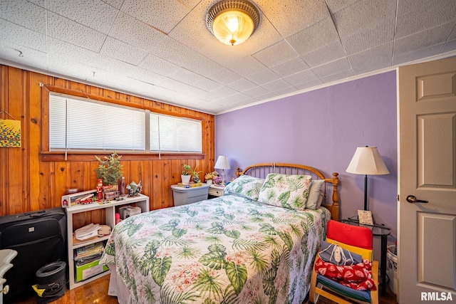 1425 N Vaughn Ave, West Peoria, IL 61604 - bedroom featuring wood finished floors, wood walls, and crown molding