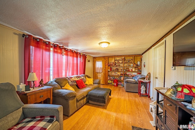 1425 N Vaughn Ave, West Peoria, IL 61604 - living room with wood finished floors, a textured ceiling, and wood walls