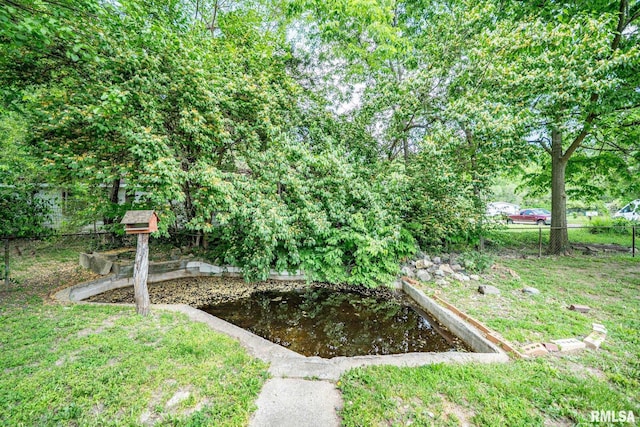 1425 N Vaughn Ave, West Peoria, IL 61604 - view of yard featuring fence and a garden pond