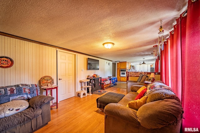 1425 N Vaughn Ave, West Peoria, IL 61604 - living area with a textured ceiling and light wood-style flooring