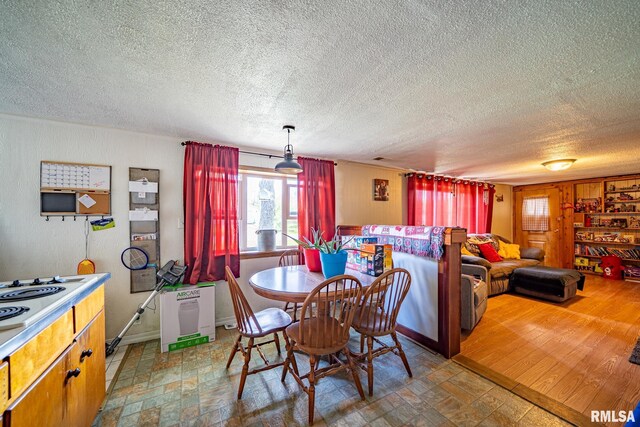 1425 N Vaughn Ave, West Peoria, IL 61604 - dining room with a textured ceiling and stone finish flooring