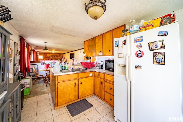 1425 N Vaughn Ave, West Peoria, IL 61604 - kitchen with white refrigerator with ice dispenser, a peninsula, a sink, black microwave, and a textured ceiling