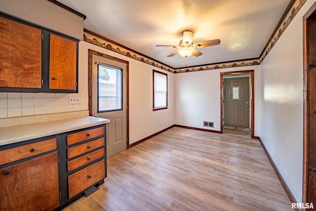 304 Meyers St, South Pekin, IL 61564 - kitchen with light wood finished floors, ceiling fan, baseboards, light countertops, and backsplash