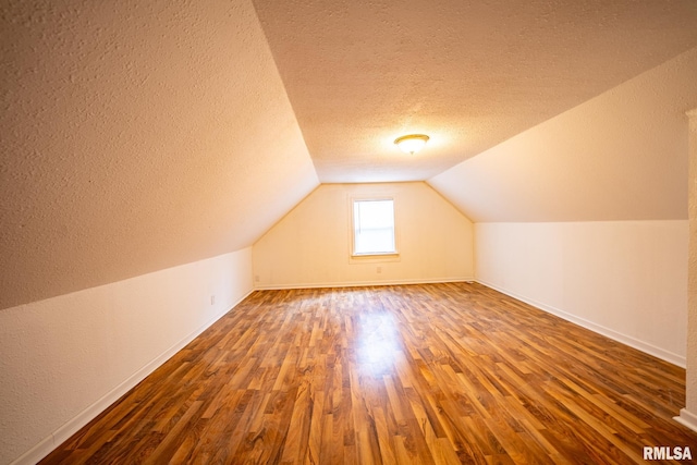 304 Meyers St, South Pekin, IL 61564 - additional living space with a textured ceiling, wood finished floors, baseboards, and lofted ceiling