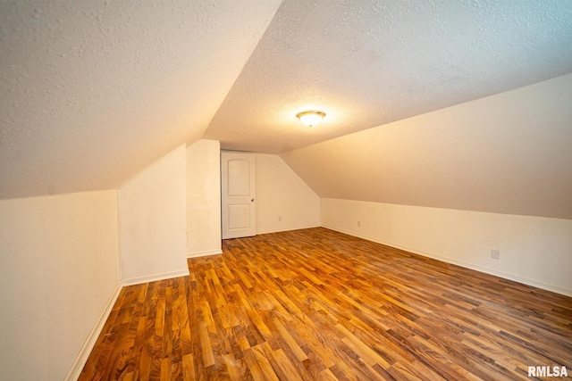 304 Meyers St, South Pekin, IL 61564 - bonus room featuring a textured ceiling, wood finished floors, vaulted ceiling, and baseboards