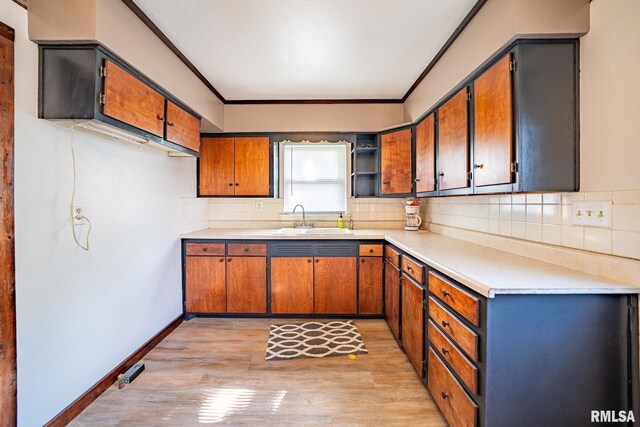 304 Meyers St, South Pekin, IL 61564 - kitchen with a sink, light wood finished floors, decorative backsplash, crown molding, and light countertops