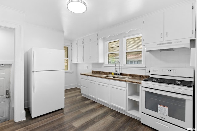 kitchen with white appliances, under cabinet range hood, a sink, dark countertops, and white cabinetry