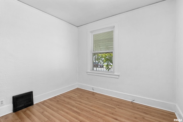 spare room with light wood finished floors and baseboards