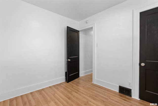 unfurnished bedroom featuring light wood-style flooring and baseboards
