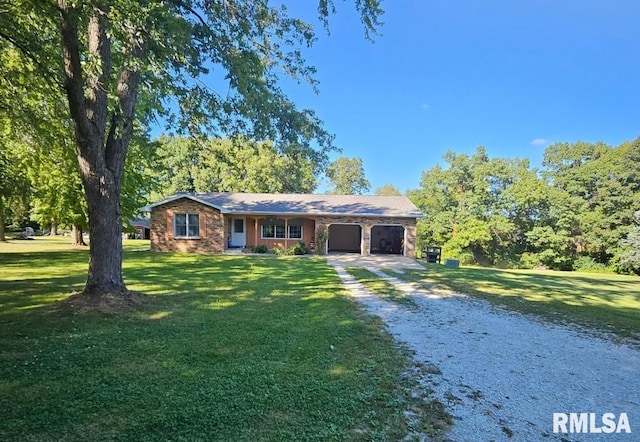 ranch-style home with gravel driveway, an attached garage, and a front lawn