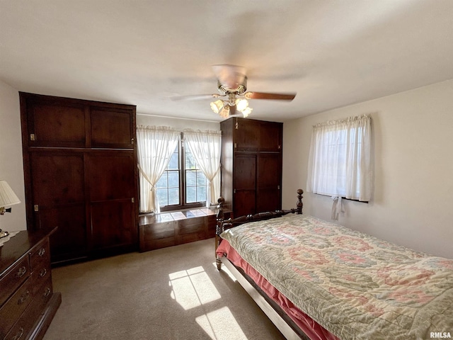 bedroom featuring light colored carpet and a ceiling fan