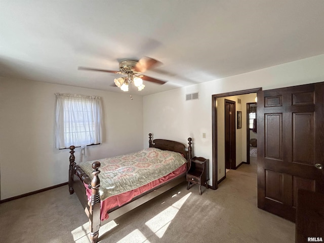 bedroom featuring light colored carpet, baseboards, and ceiling fan